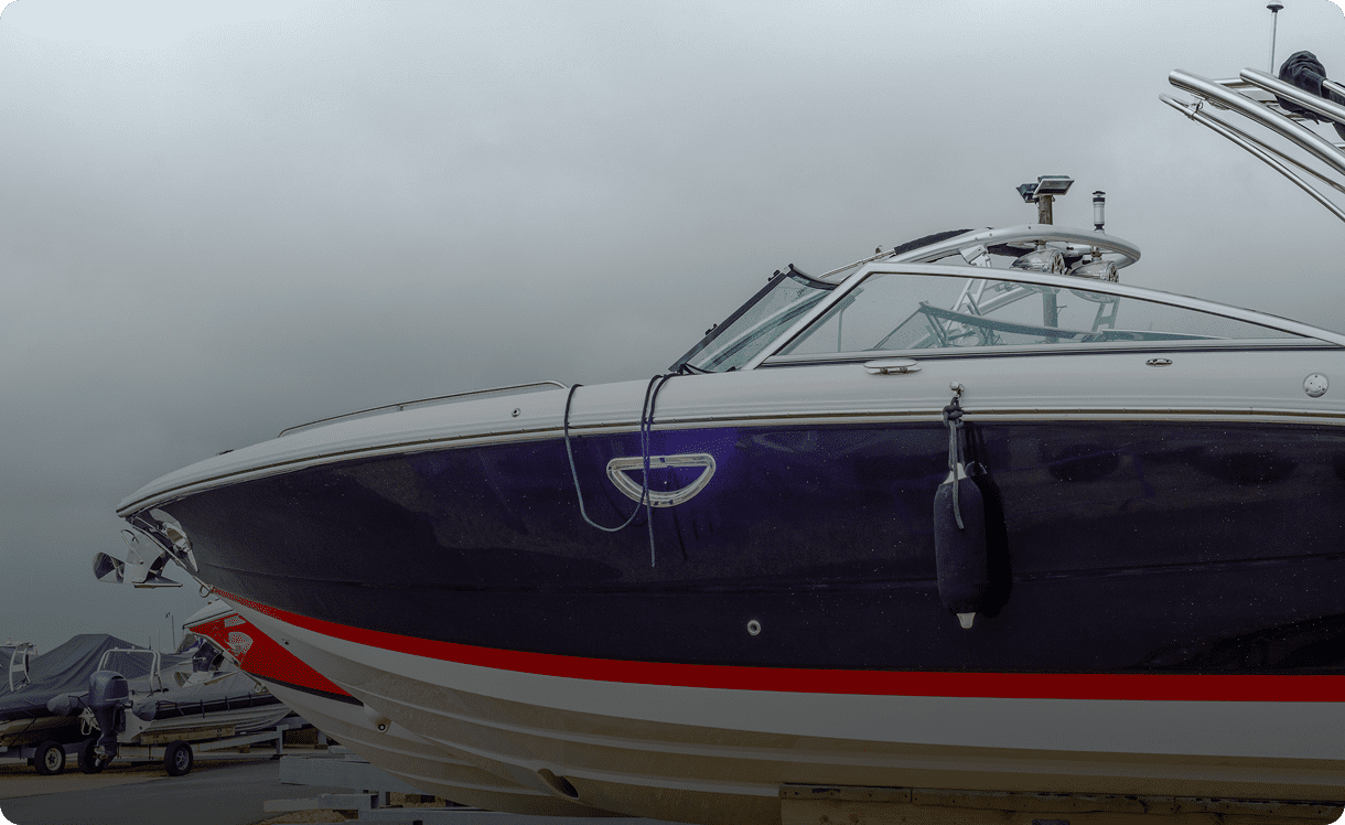 Sleek motorboat docked on a cloudy day.