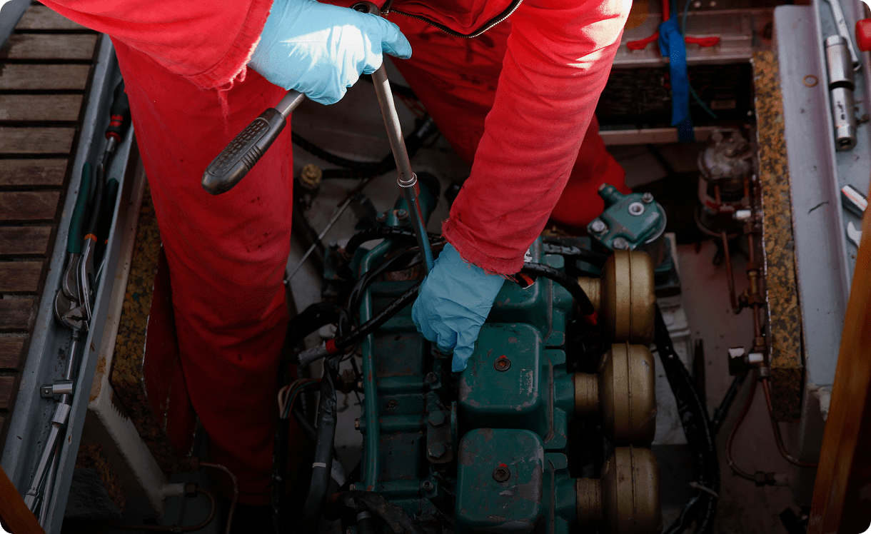 Mechanic working on boat engine