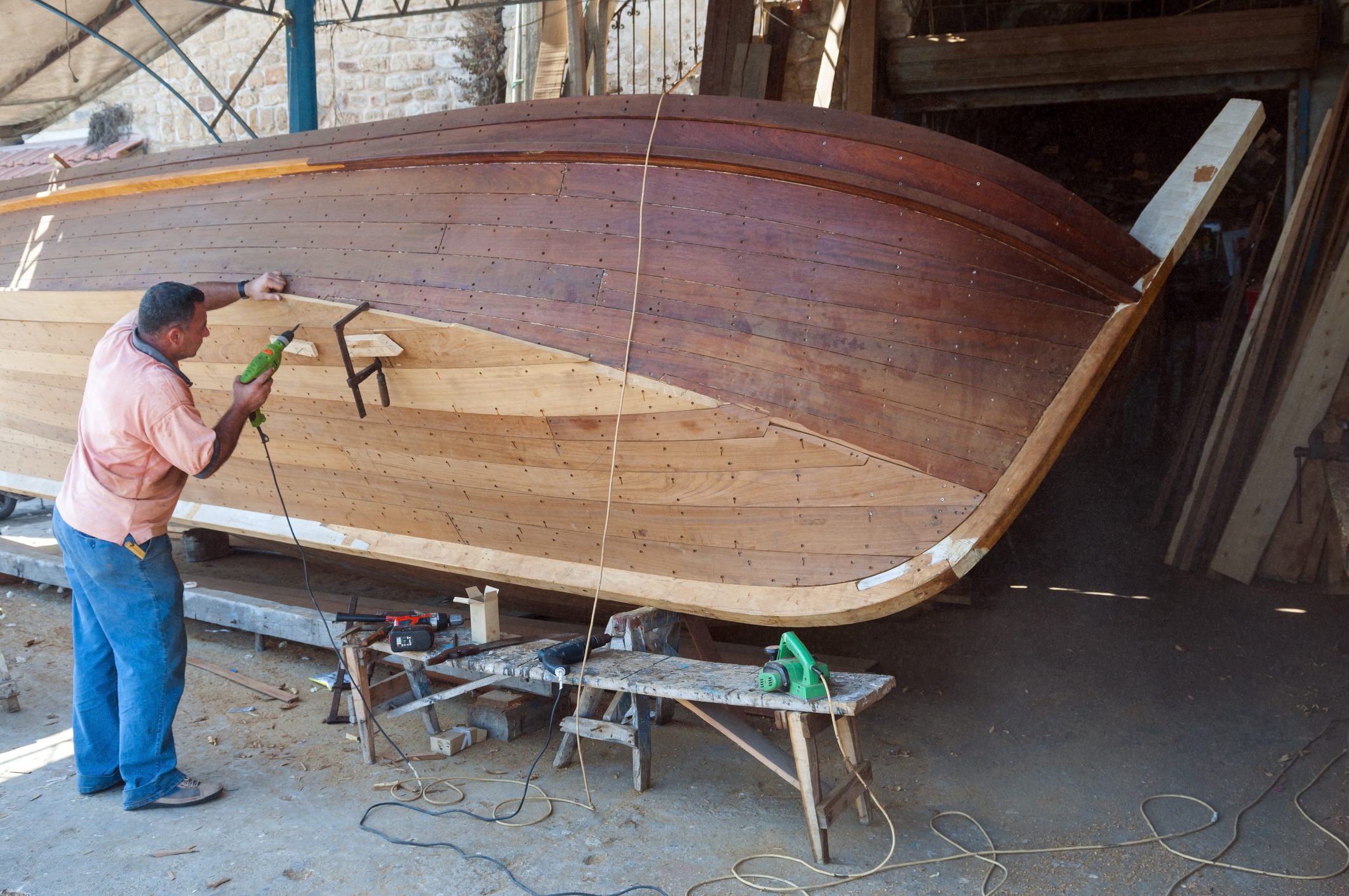 Man working on wooden boat construction