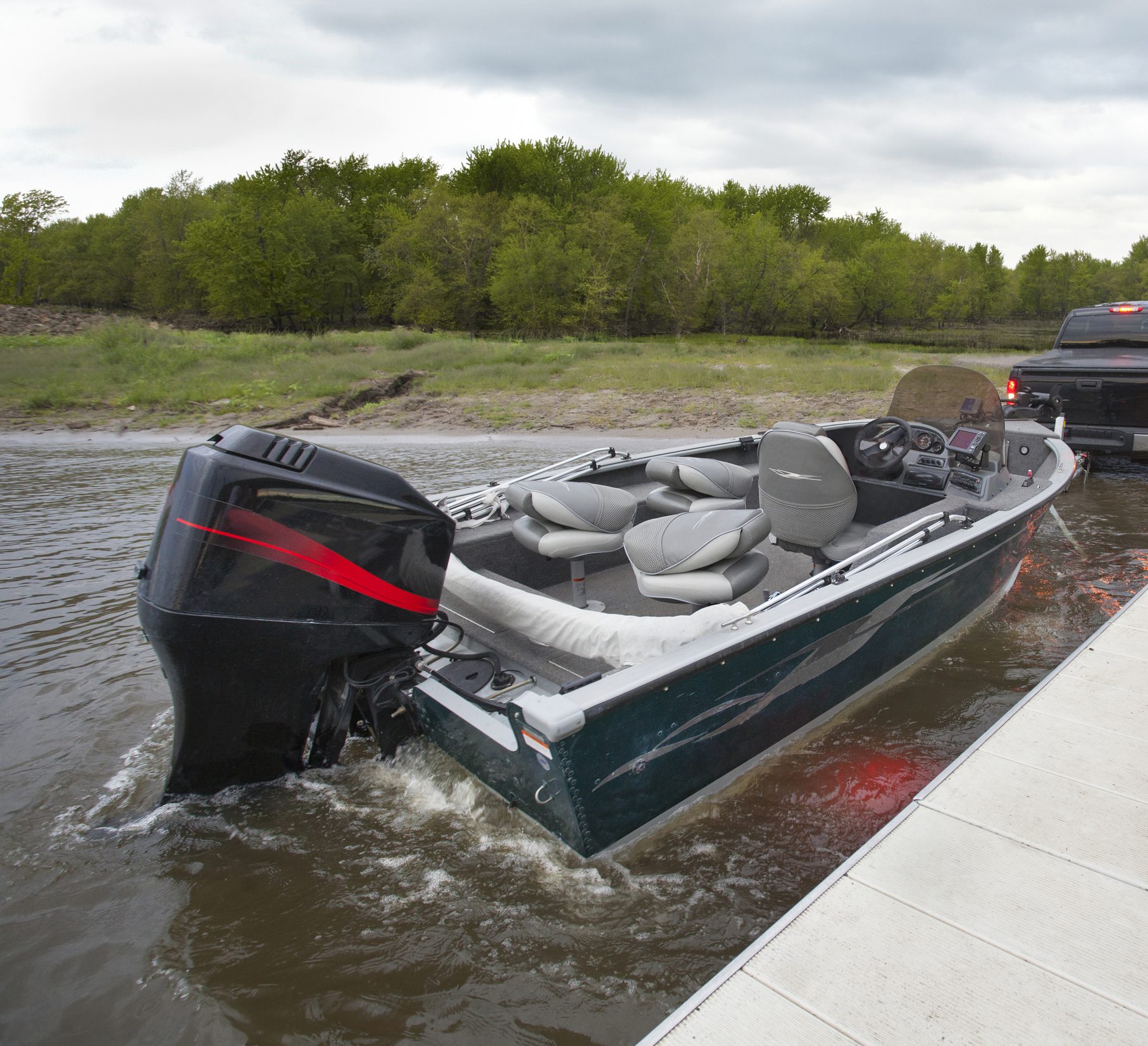 Truck launching boat into river