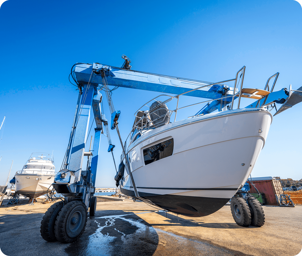 Boat lifted by crane for maintenance.